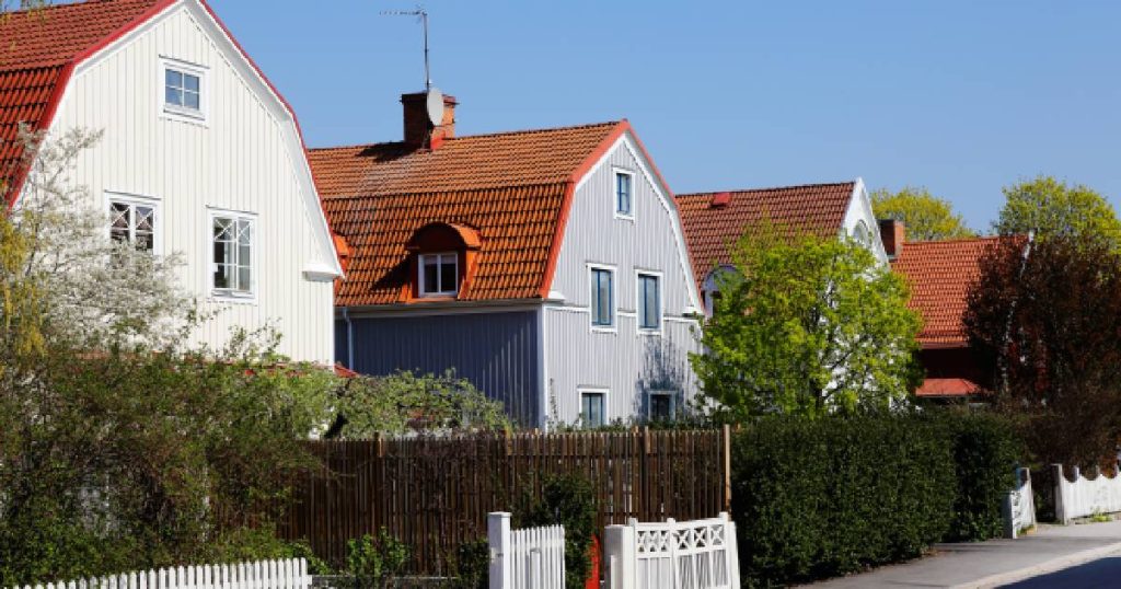 Een straat met twee woningen met monsardedak: een traditionele dakconstructie voor hellende daken met een ouderwetse, gezellige look.