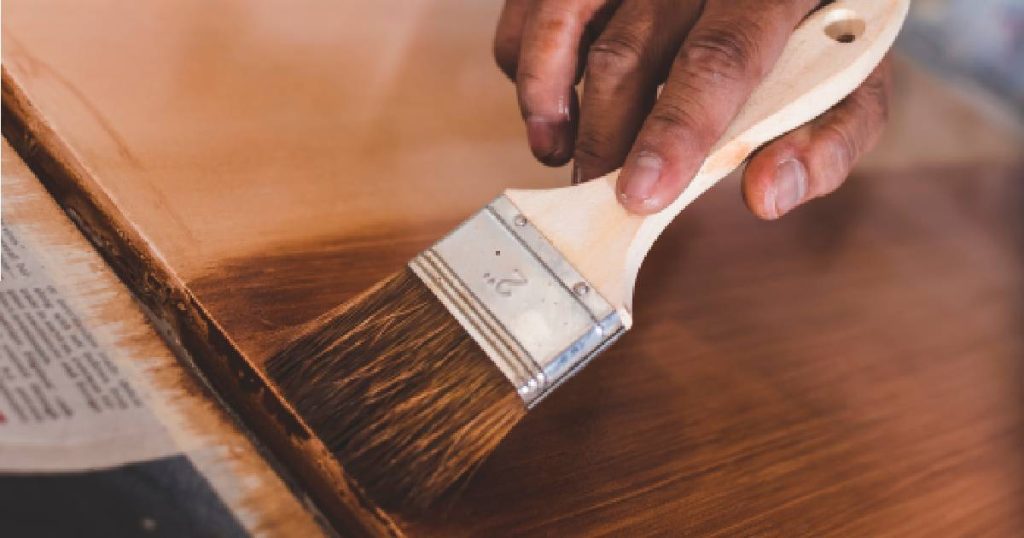 Een man is een keukenblad aan het schilderen tijdens het renoveren van de keuken.